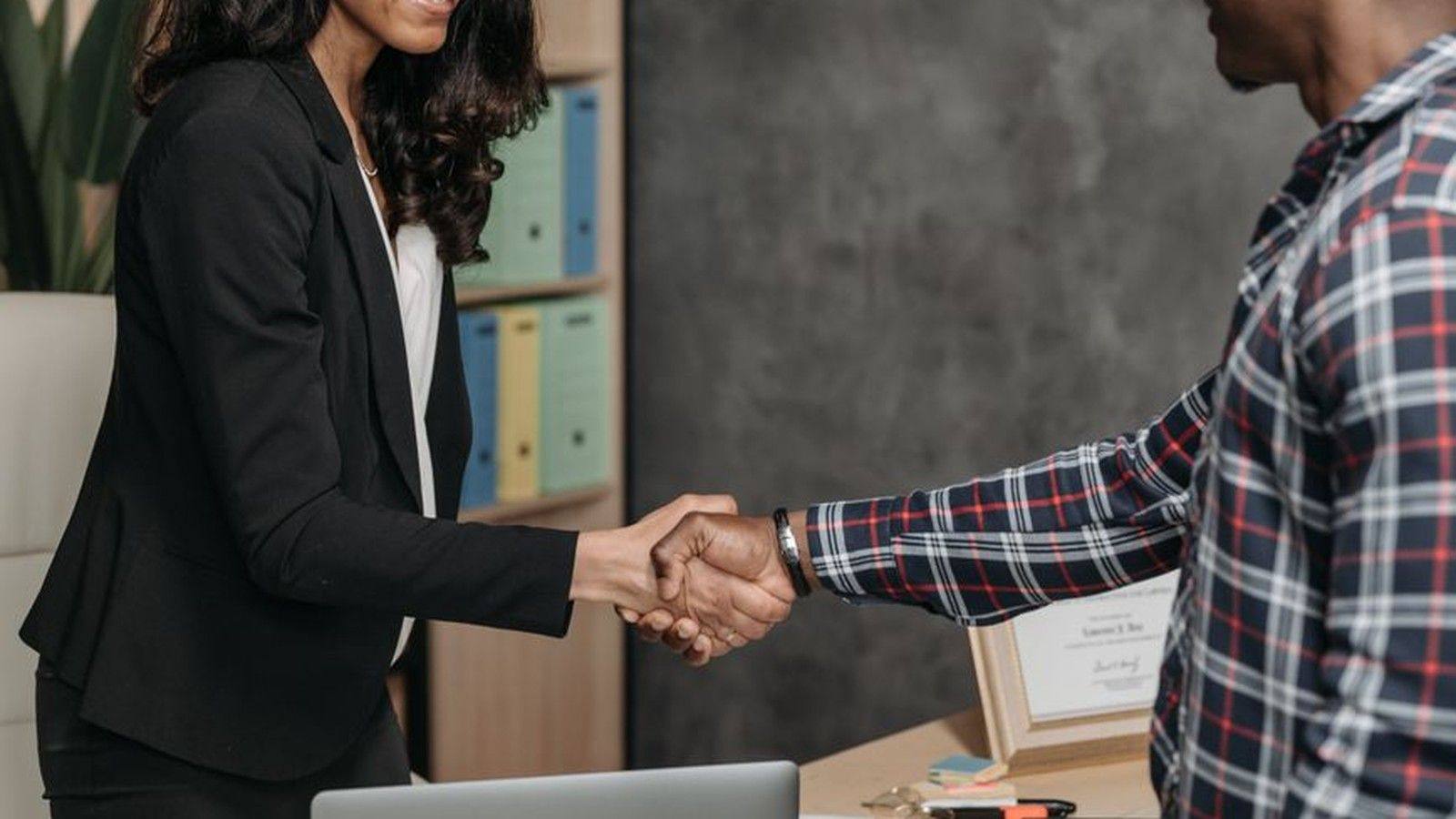 A client shaking hands with an investigator in an office, representing the consultation that helps match the right investigation firm to the right case