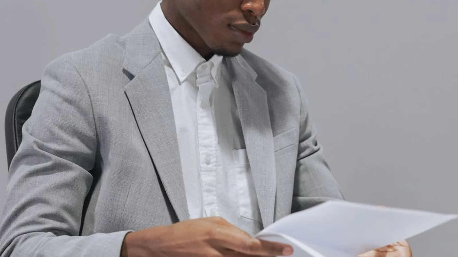 An office manager reviewing payroll documents at a desk, representing the review that catches a ghost employee on the books