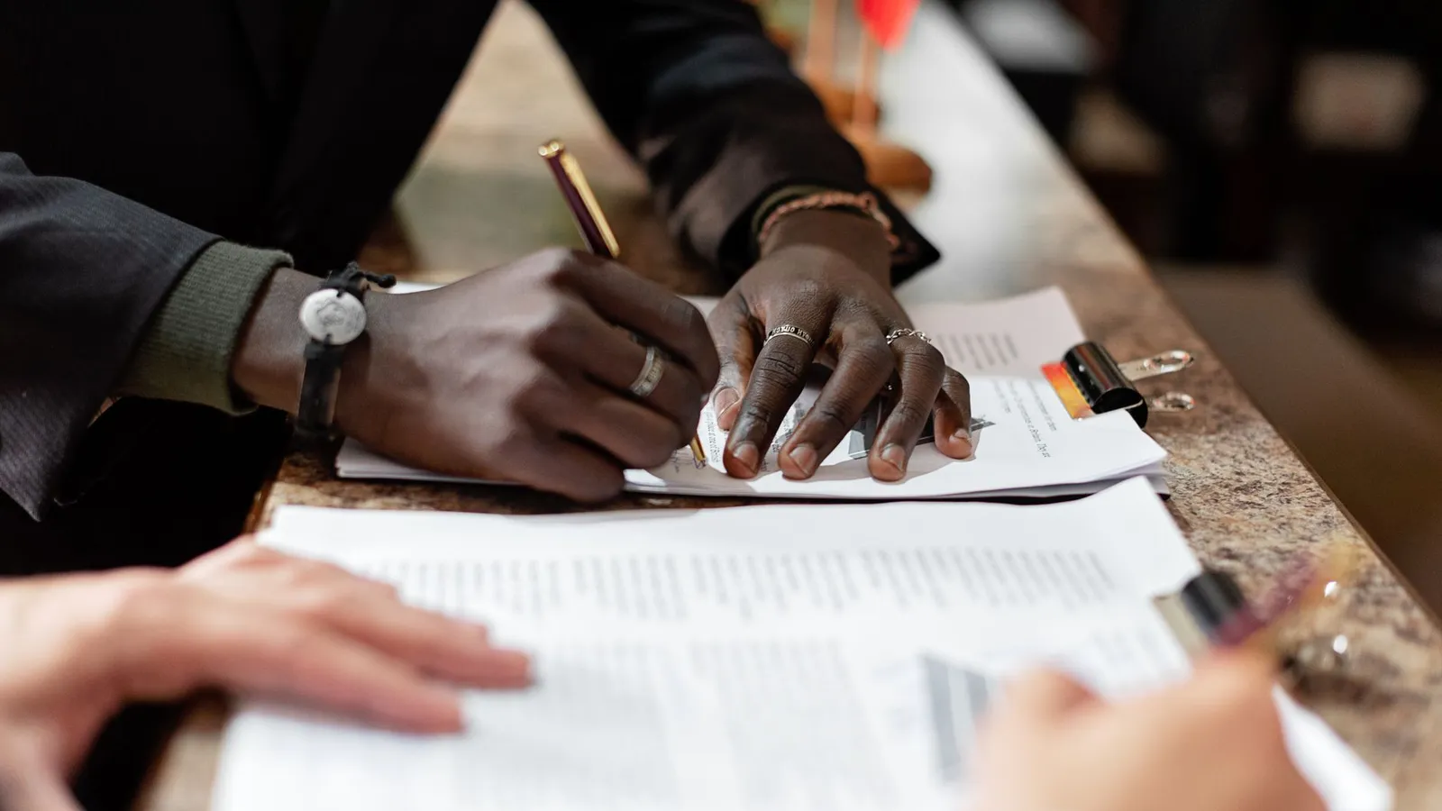 Hands signing a formal document, representing the decision about what will actually happen once the investigation's findings come back