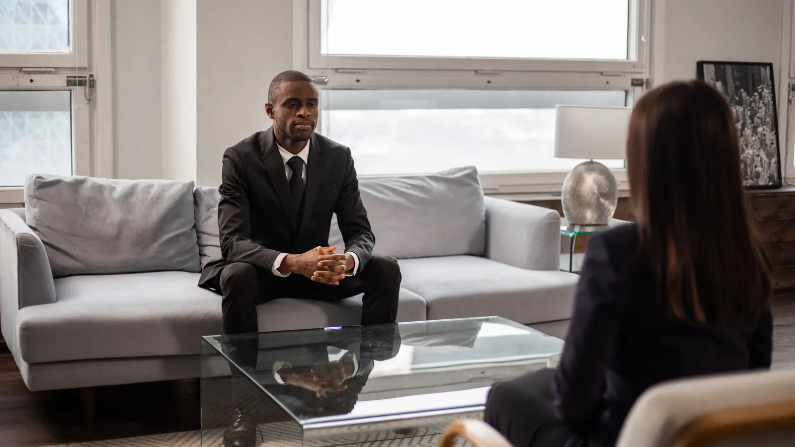 An executive candidate being interviewed in an office, representing the vetting at the center of corporate investigation
