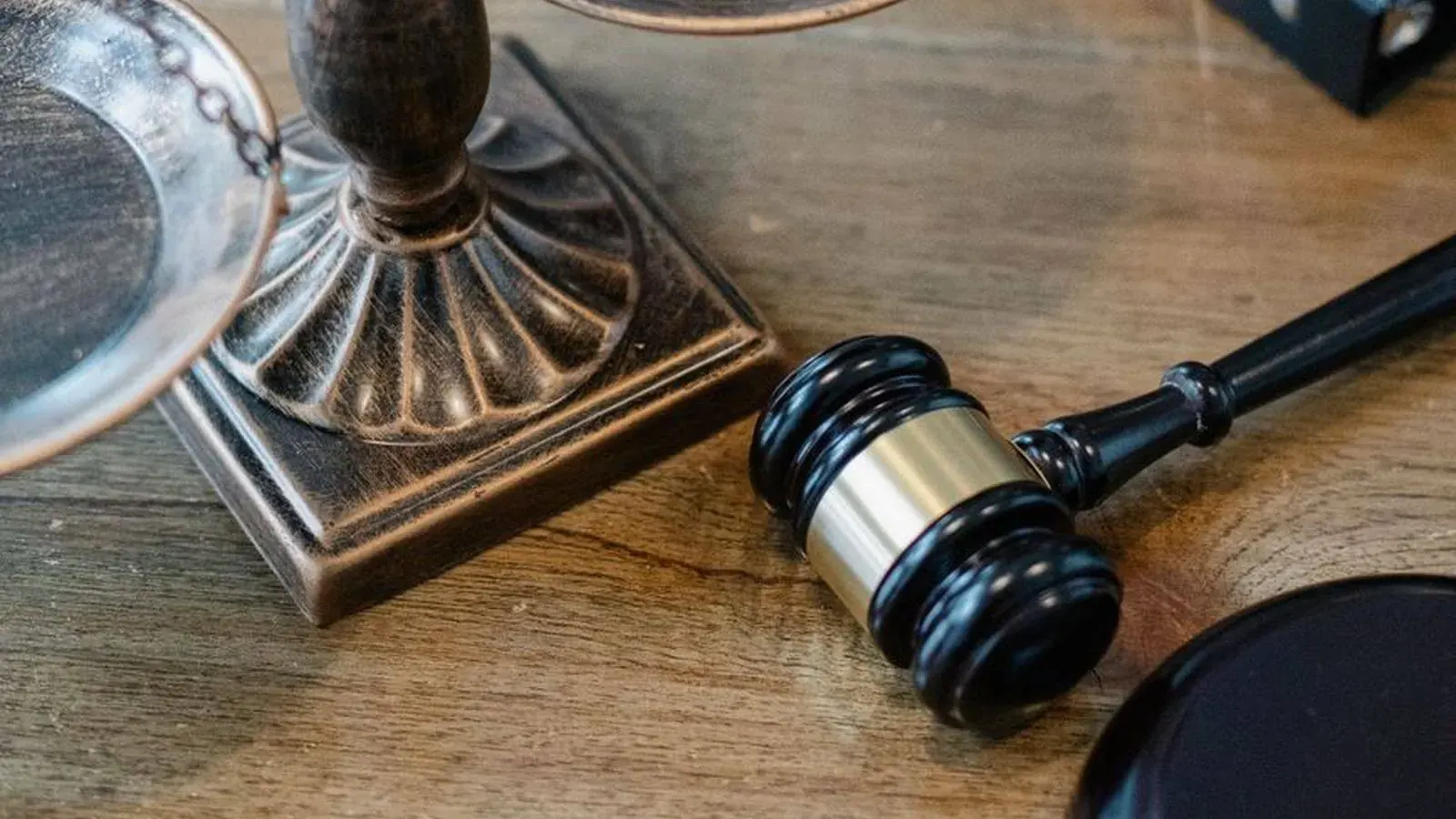 A judge's gavel next to a set of scales, representing the legal side of hiring a private investigator in Tanzania