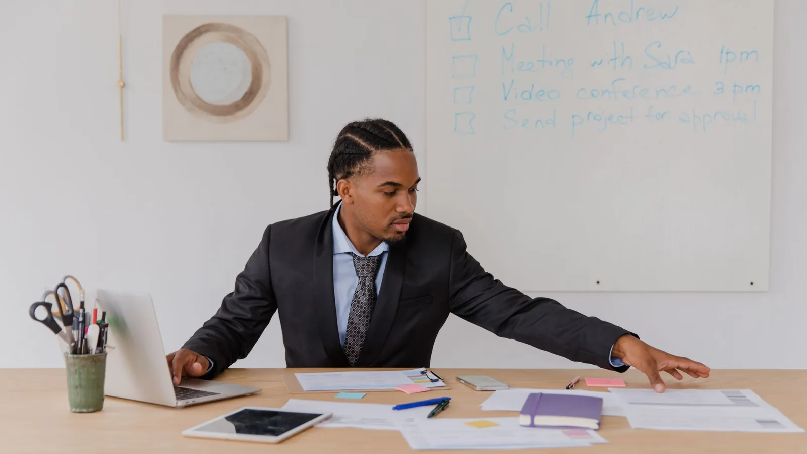 A businessman working through a checklist on a whiteboard at his desk, representing the categories international companies typically need investigated