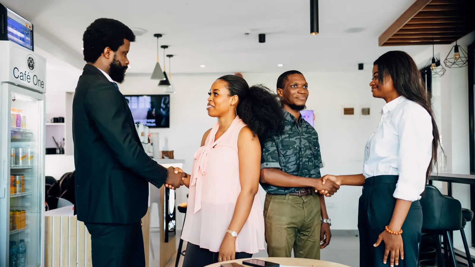 A group shaking hands in an office setting, representing the relief of reaching a resolution without having to carry the entire claims process alone