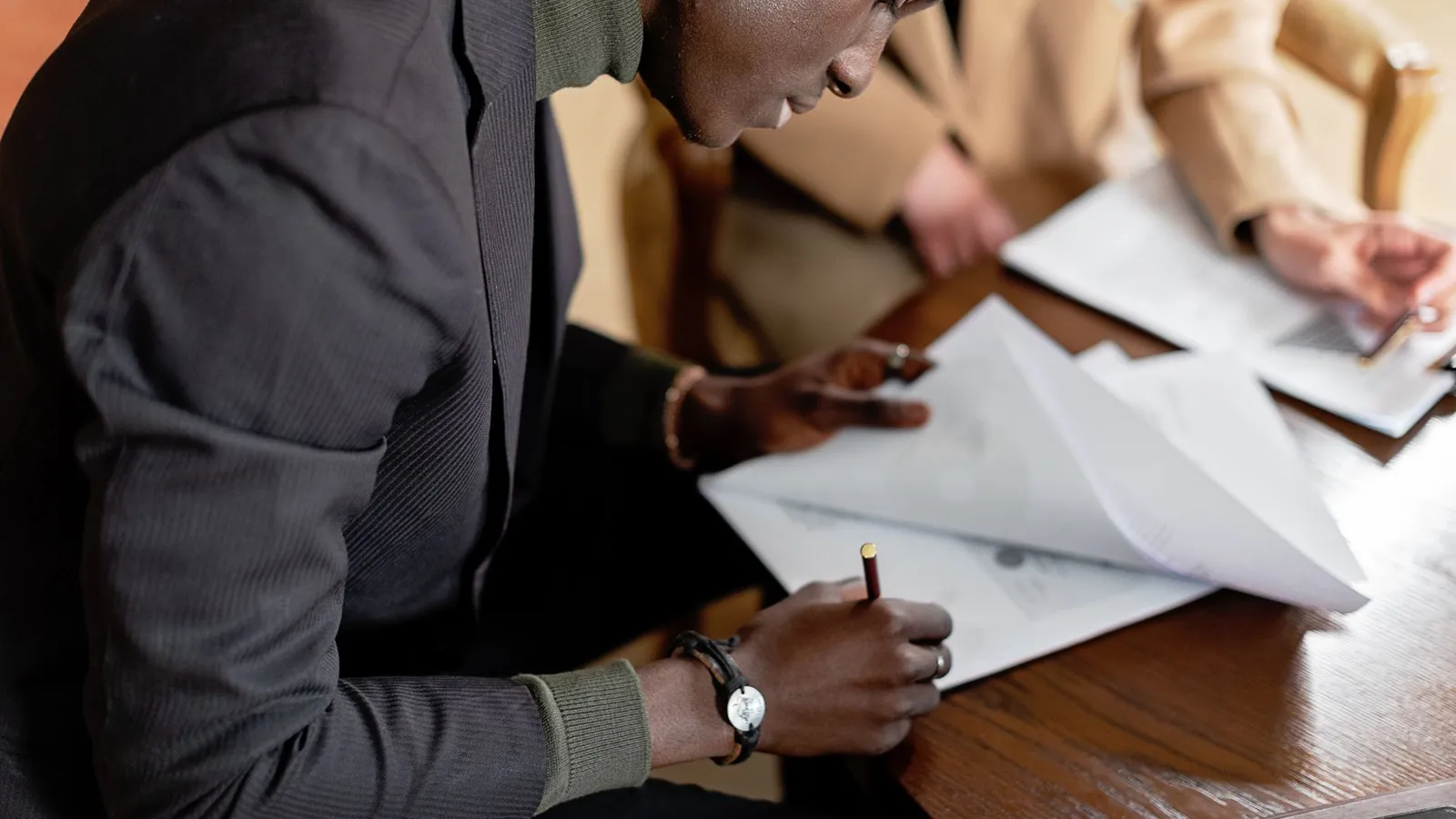 Two businessmen reviewing documents together, representing the due diligence and business use cases investigators handle beyond personal matters