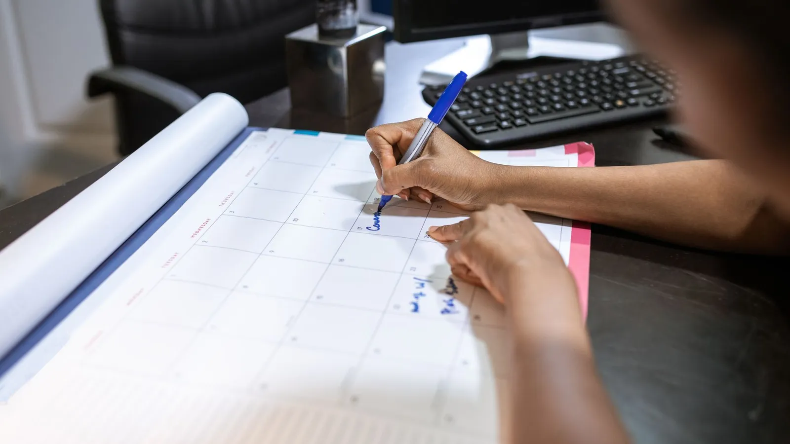 Hands marking dates on a desk calendar, representing how an investigation's timeline is scoped to what the specific case actually requires