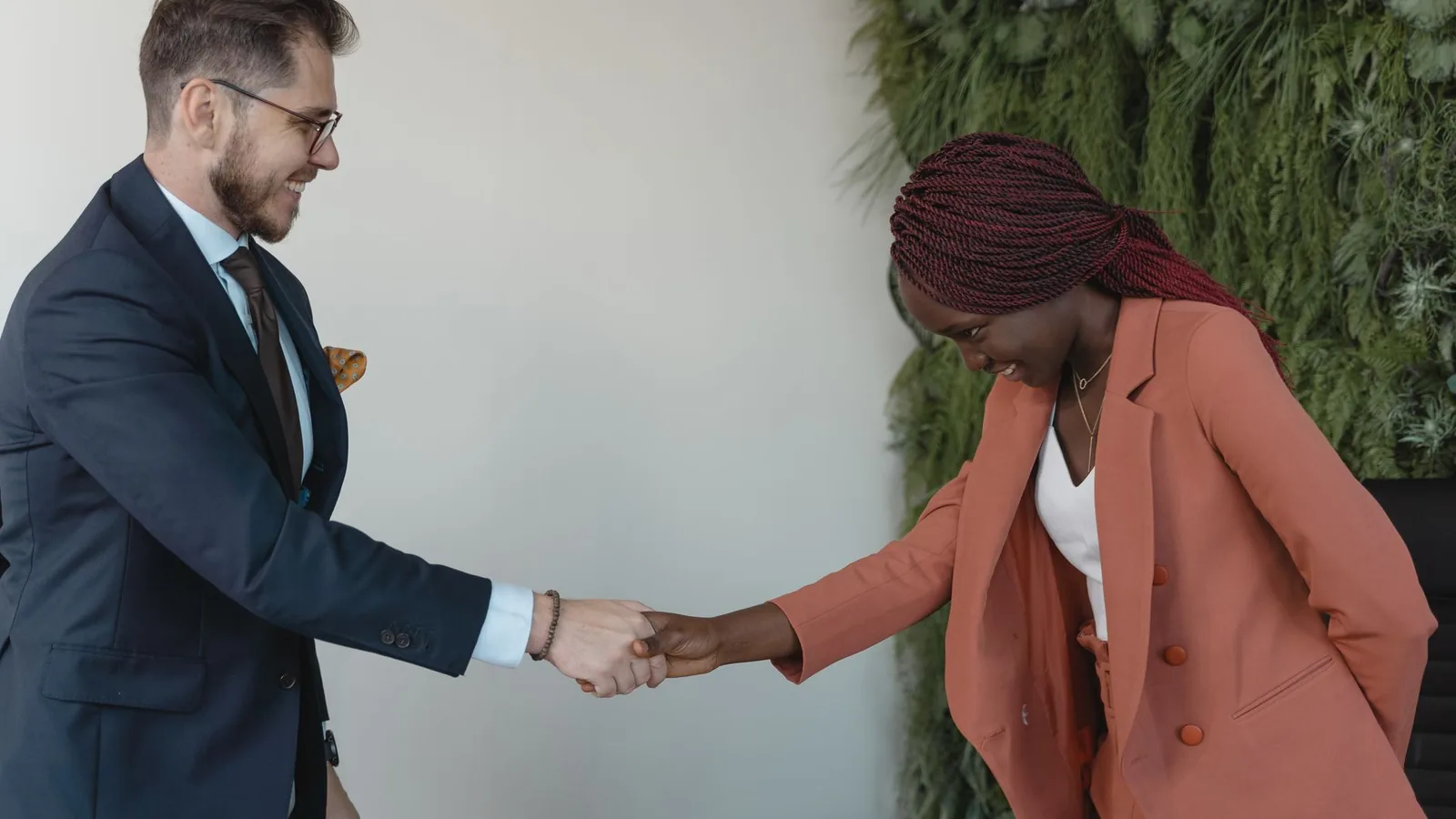 Two business partners shaking hands to seal an agreement, representing verification of a new business partnership