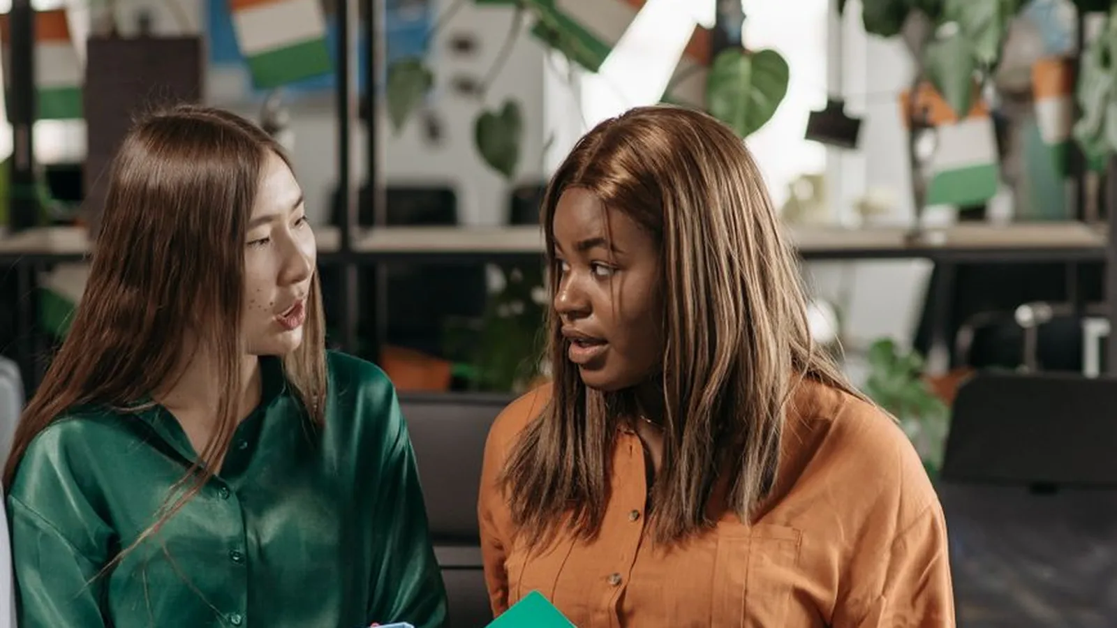 Two colleagues reviewing folders together, representing how one firm typically handles both personal and corporate cases regardless of its chosen title