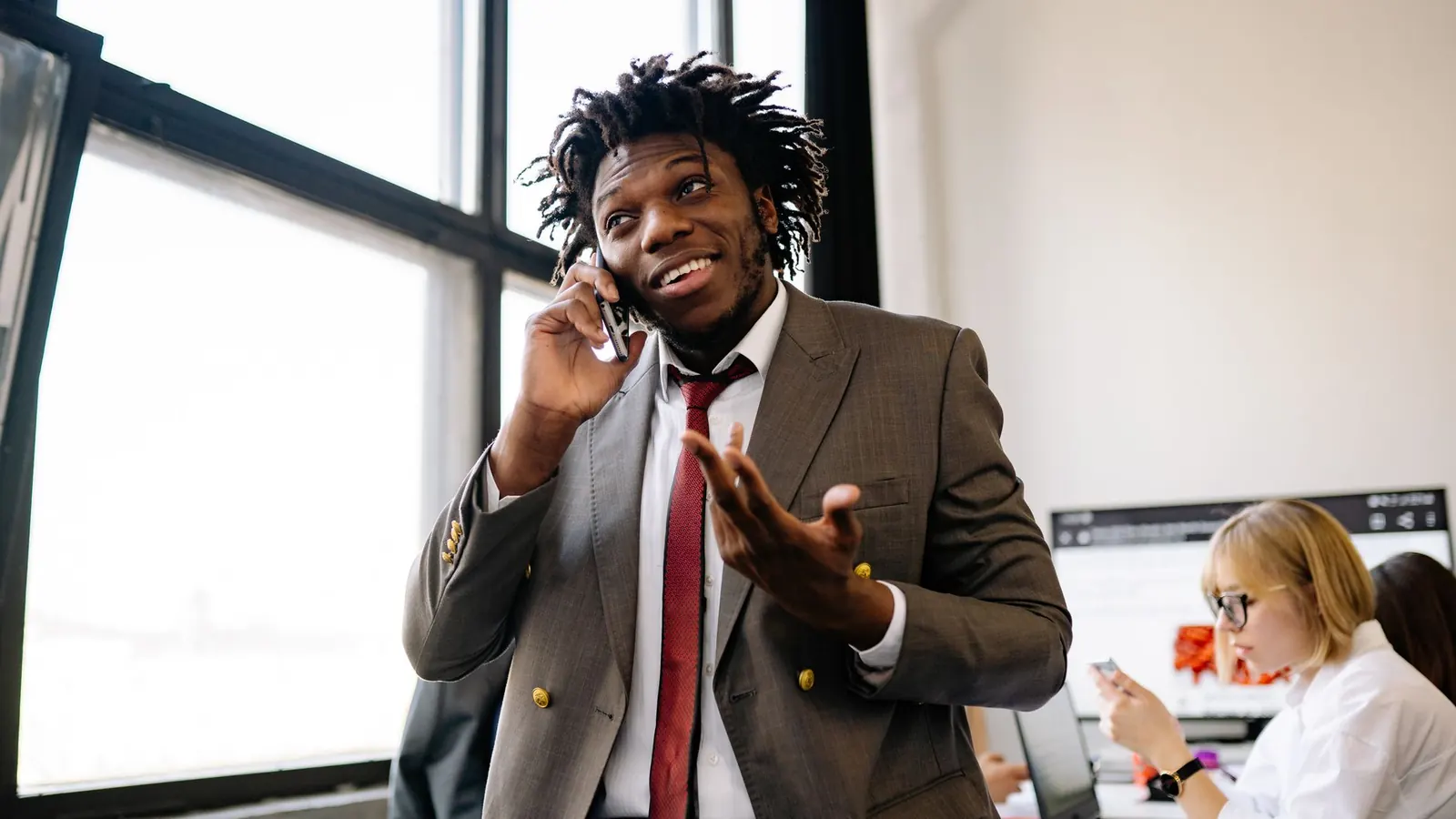 A professional on a phone call in an office, representing the client communication that happens throughout a private investigation