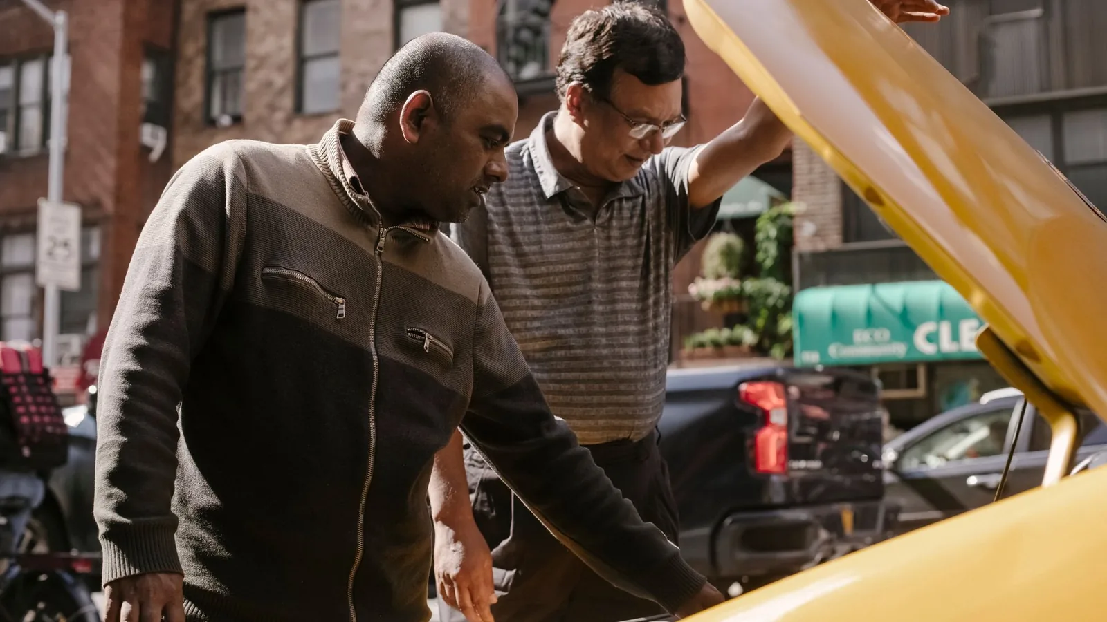 Two men inspecting a vehicle with the hood open, representing an insurance claims investigation into a motor loss