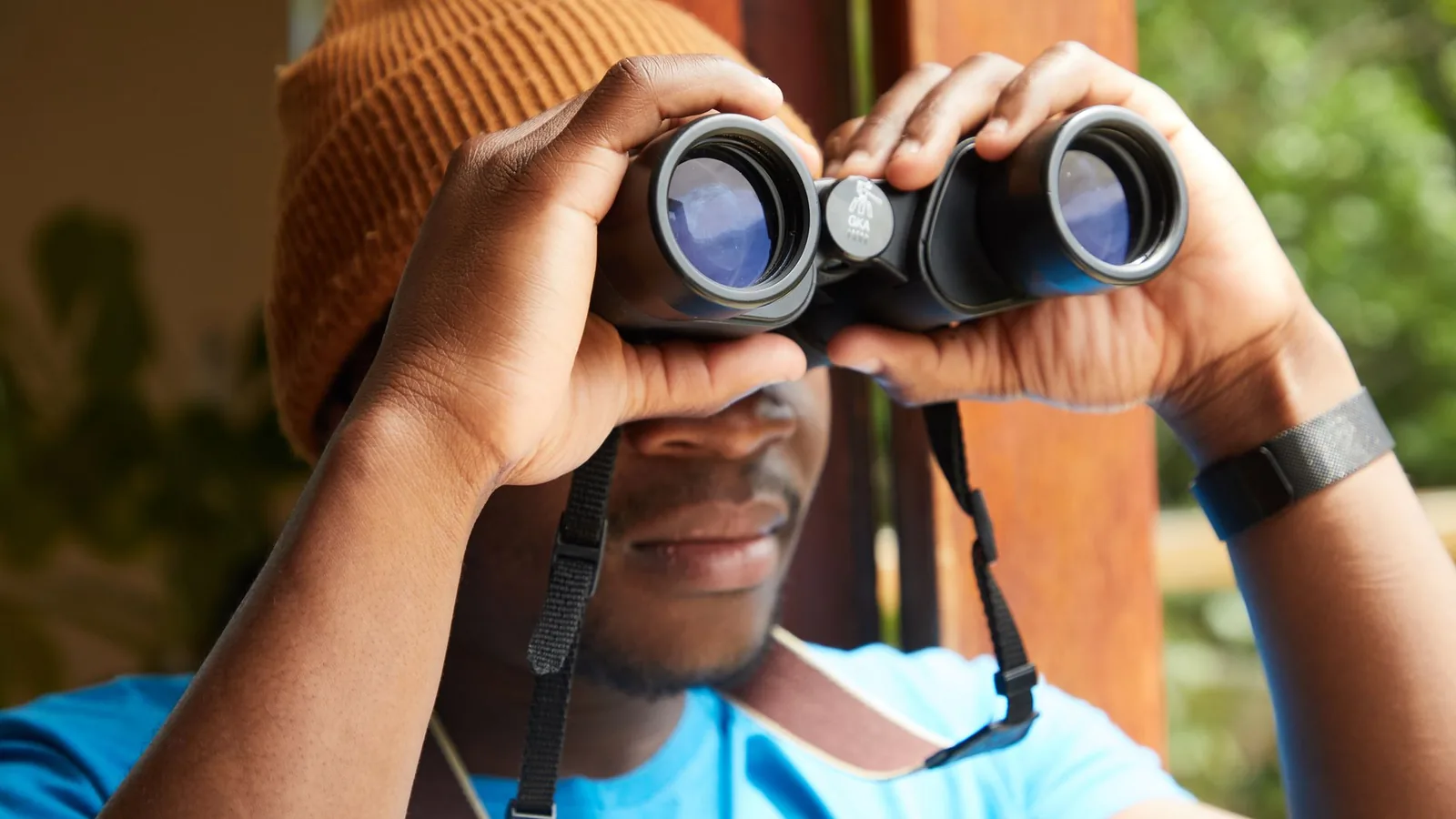 A man looking through binoculars, representing the lawful surveillance used in matrimonial and personal investigations