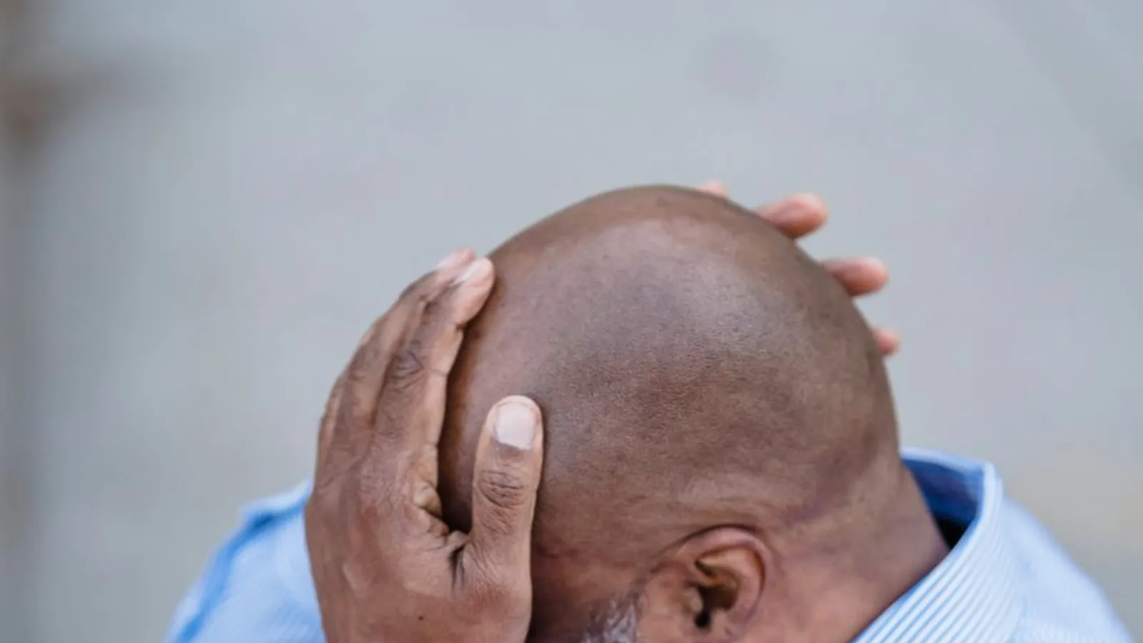 A frustrated businessman holding his head, representing the moment ongoing stock or financial losses become impossible to keep explaining away