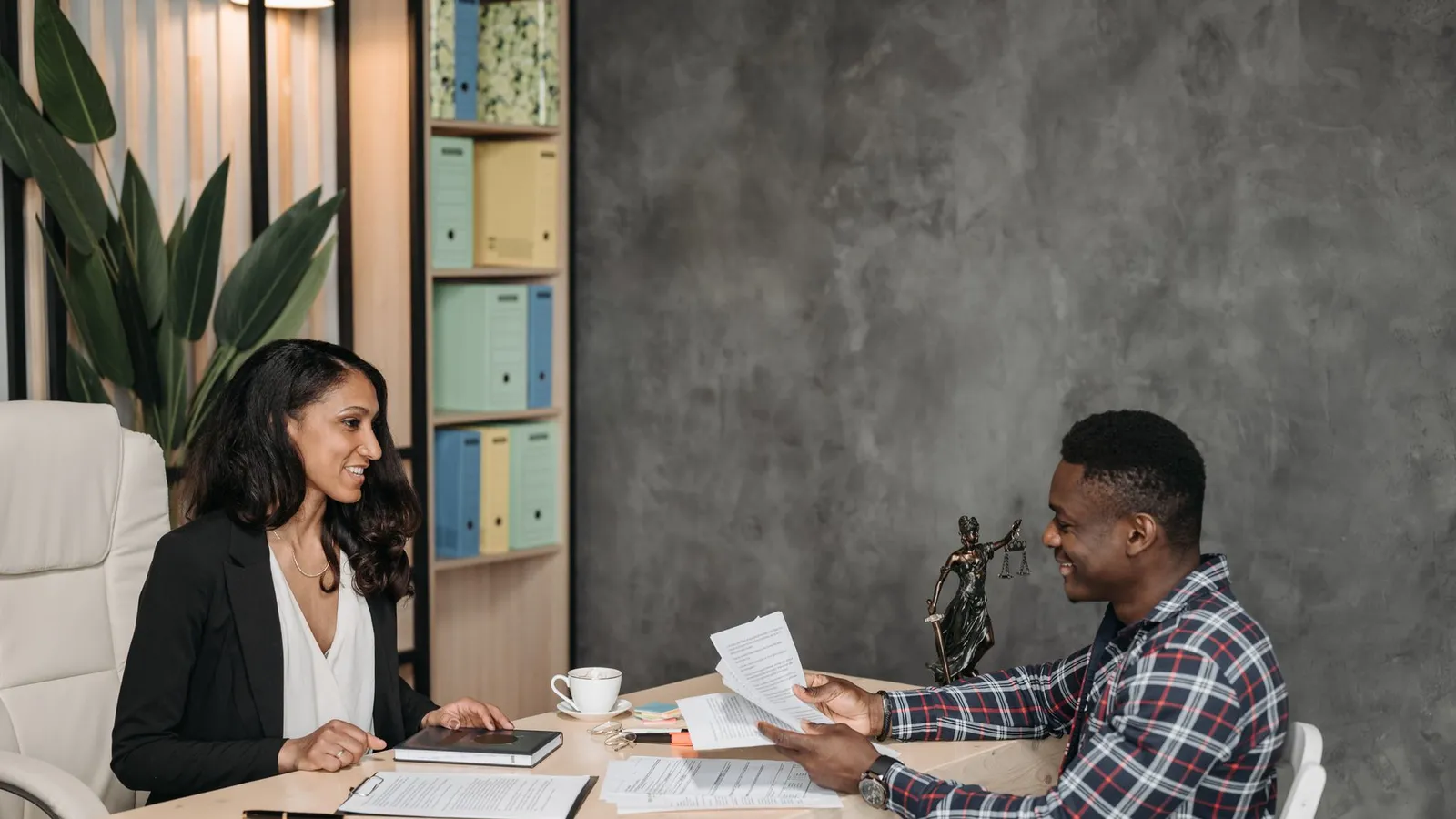 Two people reviewing legal documents together at a table, representing the properly gathered evidence a lawyer can actually use in a legal matter