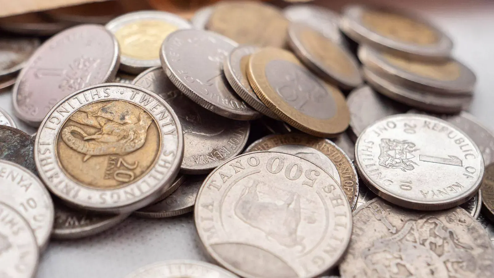 A pile of East African shilling coins