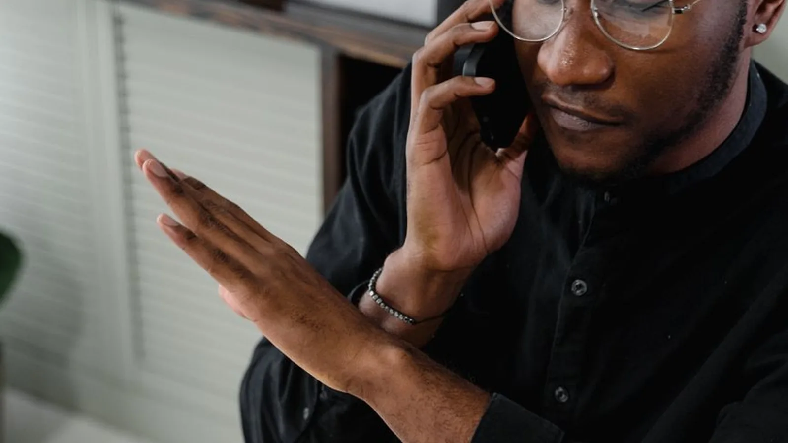 A man on the phone gesturing in frustration, representing the moment a disputed insurance claim stalls with no resolution in sight